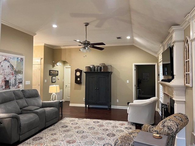 living room featuring ornamental molding, a fireplace, dark hardwood / wood-style floors, lofted ceiling, and ceiling fan