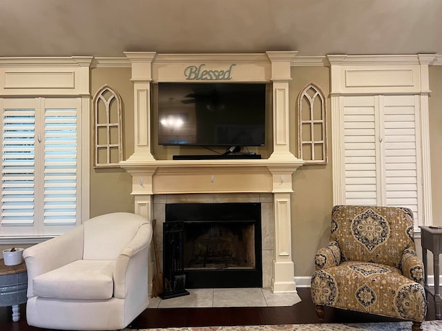 living area with crown molding and a fireplace