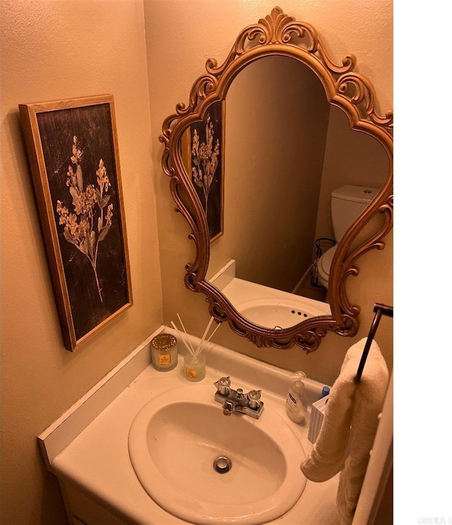 bathroom featuring vanity and toilet