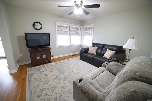 living room with hardwood / wood-style floors and ceiling fan