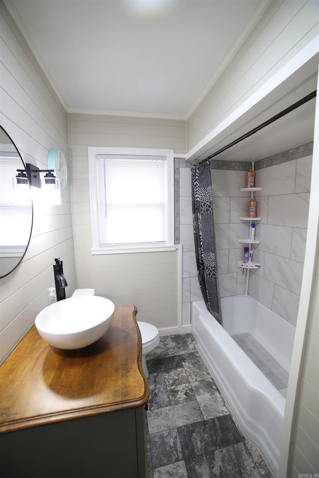 full bathroom featuring toilet, sink, ornamental molding, and shower / bathtub combination with curtain