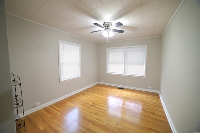 spare room with ornamental molding, light wood-type flooring, and ceiling fan