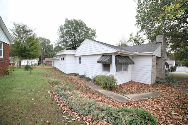 view of side of home featuring a lawn