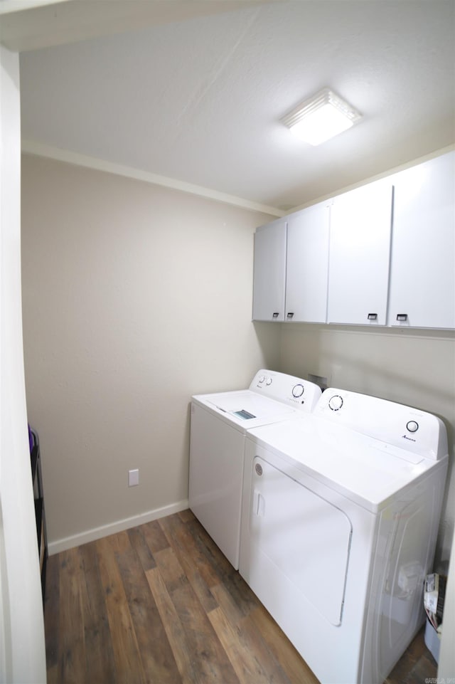 clothes washing area featuring cabinets, dark wood-type flooring, and independent washer and dryer