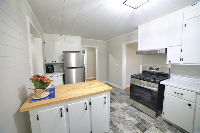 kitchen featuring crown molding, wooden counters, appliances with stainless steel finishes, exhaust hood, and white cabinets