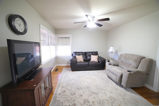 living room with hardwood / wood-style floors and ceiling fan