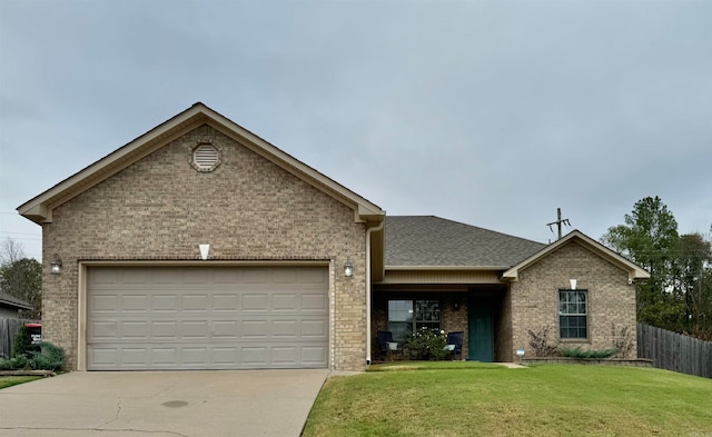 single story home with a garage and a front lawn