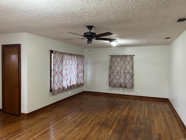 spare room featuring ceiling fan, dark hardwood / wood-style flooring, and a textured ceiling