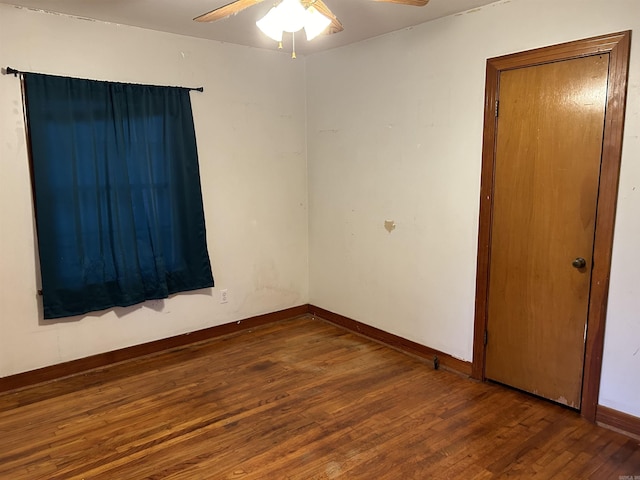 spare room featuring dark hardwood / wood-style flooring and ceiling fan