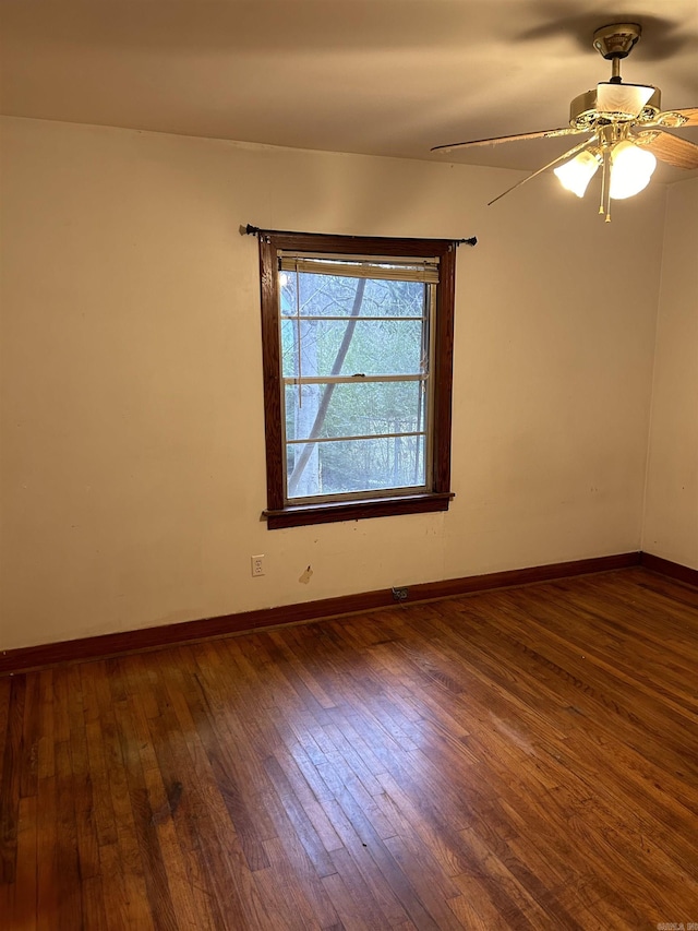 spare room featuring ceiling fan and dark hardwood / wood-style flooring