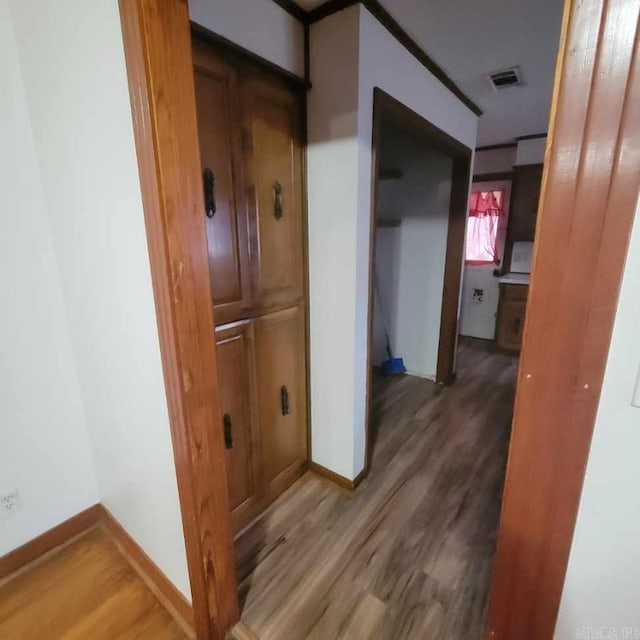 corridor with hardwood / wood-style floors