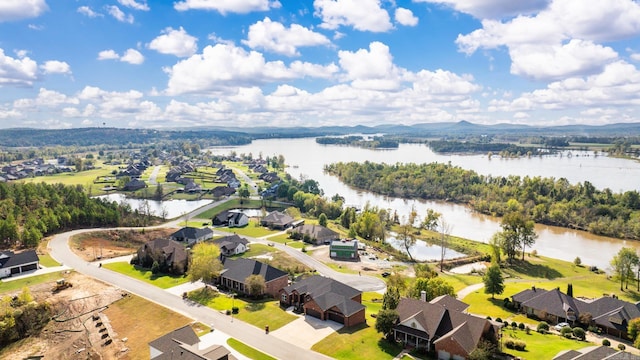 drone / aerial view featuring a water and mountain view