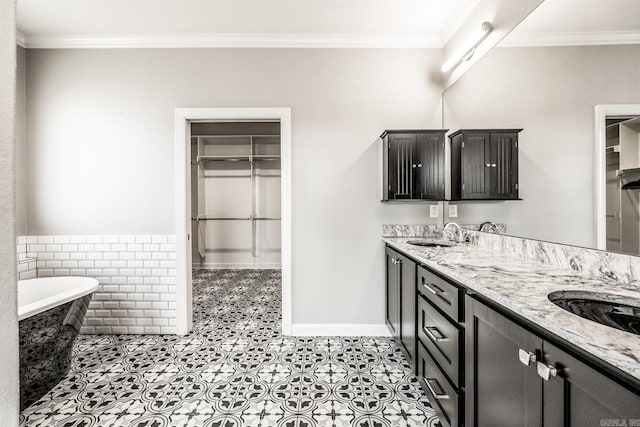 bathroom featuring vanity, a bathtub, and ornamental molding