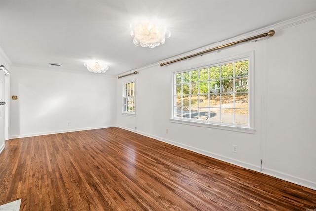 unfurnished room featuring hardwood / wood-style floors, a notable chandelier, and ornamental molding