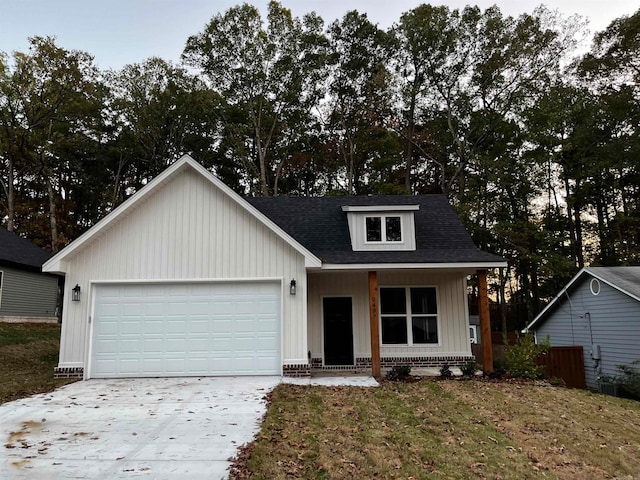 view of front facade with a garage, a front lawn, and a porch