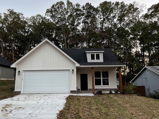 2497 Janet, Benton, AR 72015 - view of front of property featuring an attached garage, driveway, a shingled roof, a front yard, and board and batten siding