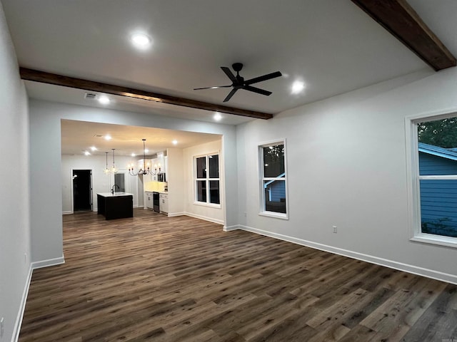 unfurnished living room featuring ceiling fan with notable chandelier, beam ceiling, and dark hardwood / wood-style flooring