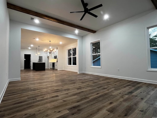 unfurnished living room with beamed ceiling, dark hardwood / wood-style floors, and ceiling fan with notable chandelier