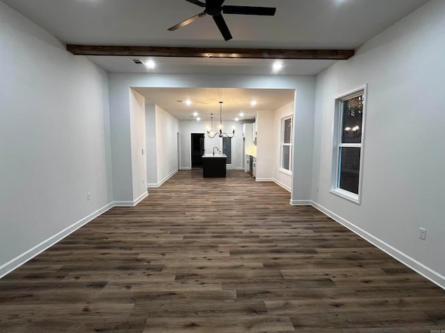 interior space with dark wood-type flooring, beamed ceiling, sink, and an inviting chandelier