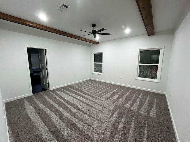 carpeted empty room with ceiling fan and beam ceiling