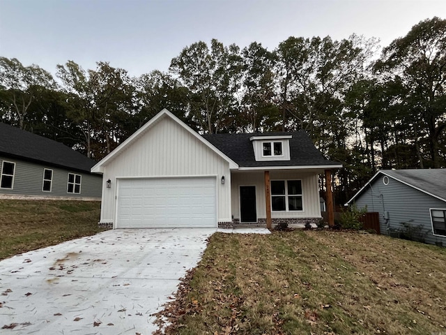 2497 Janet, Benton, AR 72015 - view of front of property with an attached garage, concrete driveway, board and batten siding, and a front yard
