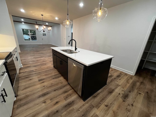 kitchen featuring stainless steel appliances, white cabinetry, dark hardwood / wood-style floors, sink, and a kitchen island with sink