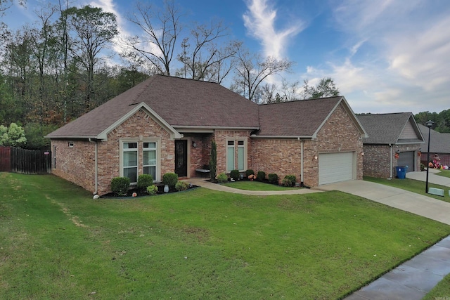 single story home featuring a garage and a front yard