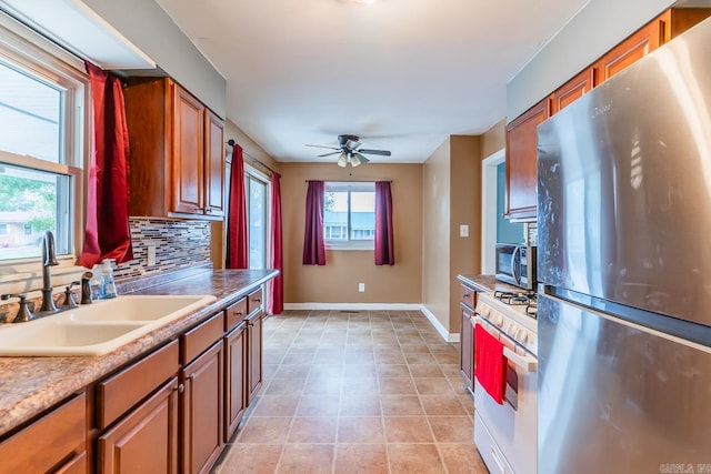 kitchen with stainless steel appliances, light tile patterned flooring, sink, tasteful backsplash, and ceiling fan