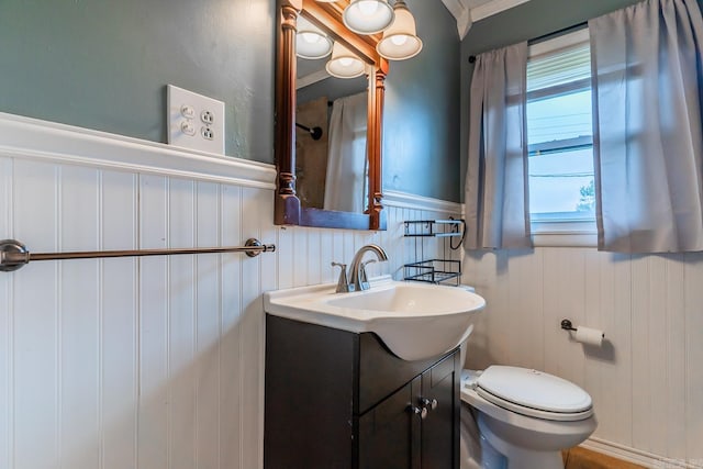 bathroom featuring crown molding, vanity, and toilet