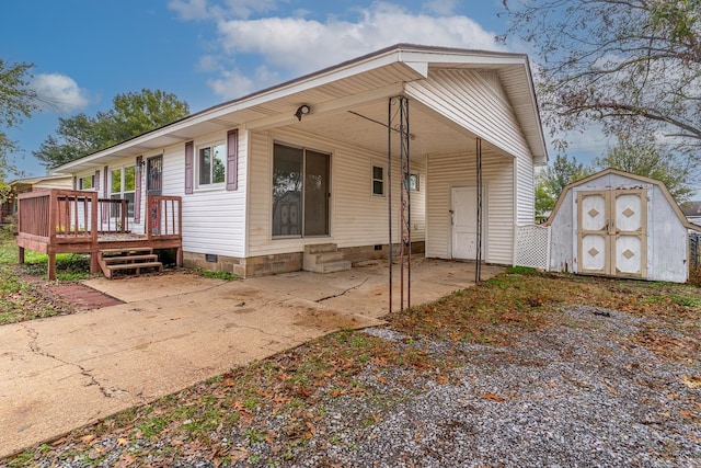 view of front facade with a deck and a storage shed