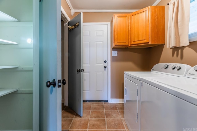 laundry area with cabinets, light tile patterned flooring, crown molding, and washer and clothes dryer