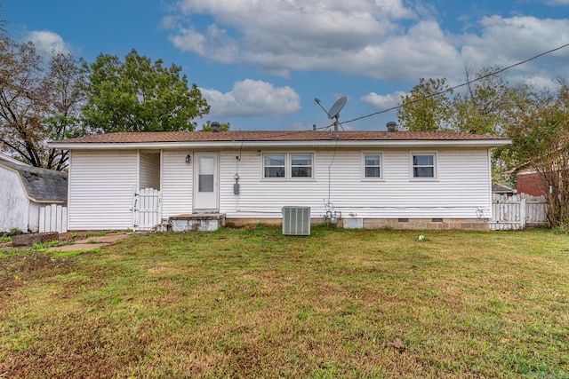 back of house with a yard and cooling unit