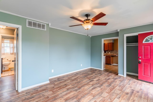 interior space featuring light hardwood / wood-style flooring, ceiling fan, and crown molding