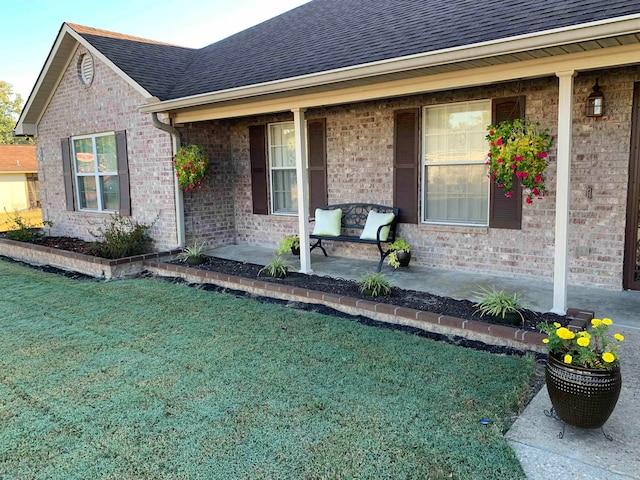 exterior space featuring a porch and a lawn