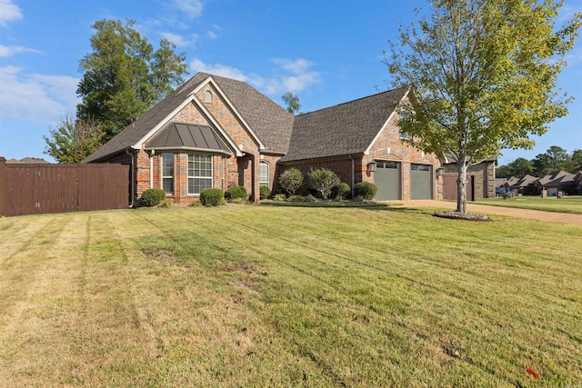 view of front of house featuring a front lawn and a garage