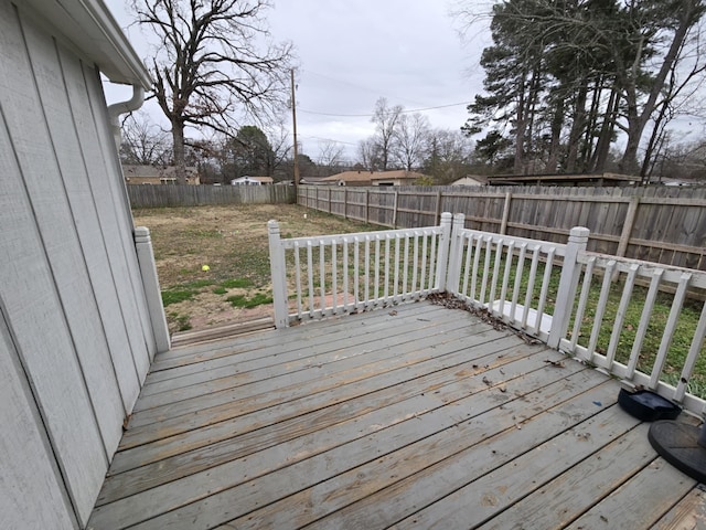 wooden deck featuring a lawn