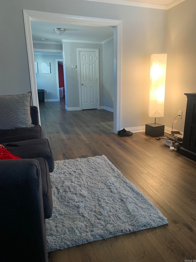 living room featuring ornamental molding and dark hardwood / wood-style flooring