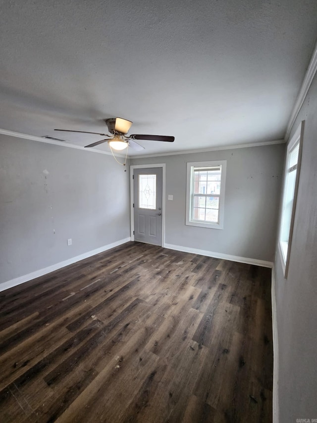 interior space featuring dark hardwood / wood-style flooring, a textured ceiling, ornamental molding, and ceiling fan