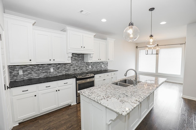 kitchen with stainless steel stove, dark hardwood / wood-style flooring, hanging light fixtures, sink, and white cabinets