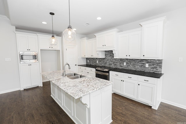 kitchen with white cabinetry, sink, appliances with stainless steel finishes, a kitchen island with sink, and dark hardwood / wood-style flooring