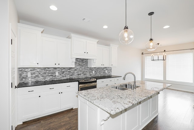 kitchen with stainless steel range with electric cooktop, dark hardwood / wood-style floors, pendant lighting, sink, and white cabinets