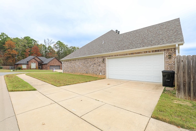 view of side of property with a garage and a yard