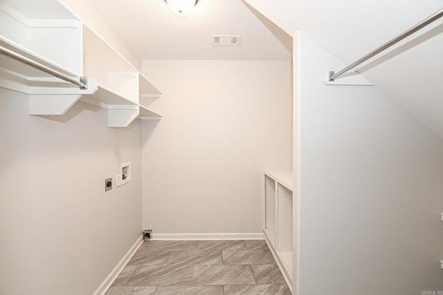 clothes washing area featuring hookup for a washing machine and hookup for an electric dryer