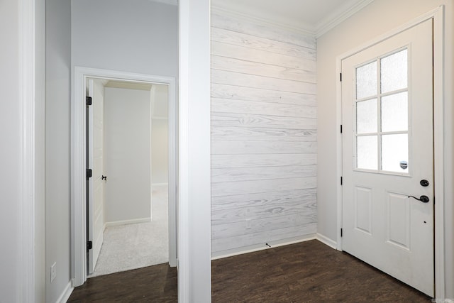 doorway featuring wood walls, dark wood-type flooring, and crown molding