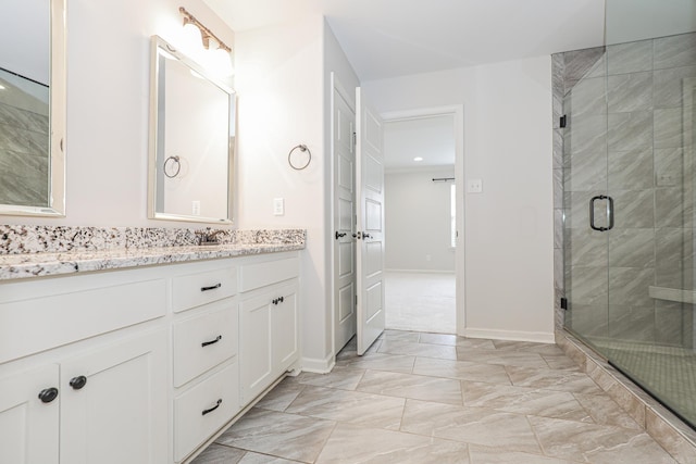 bathroom featuring vanity and a shower with door