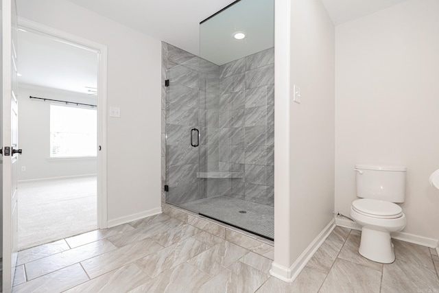 bathroom with toilet and an enclosed shower