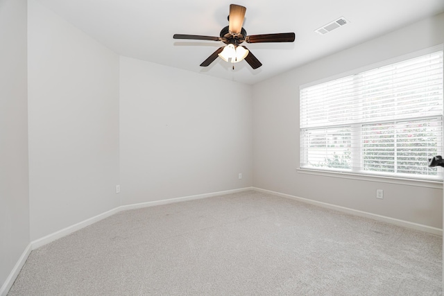 carpeted spare room with ceiling fan