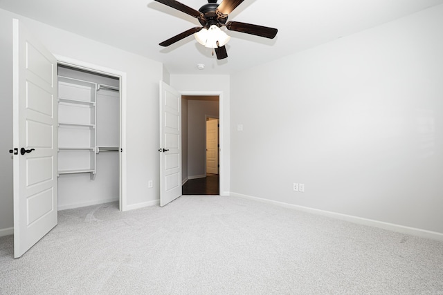 unfurnished bedroom with ceiling fan, light carpet, and a closet