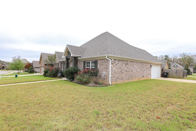 view of side of property featuring a garage and a yard