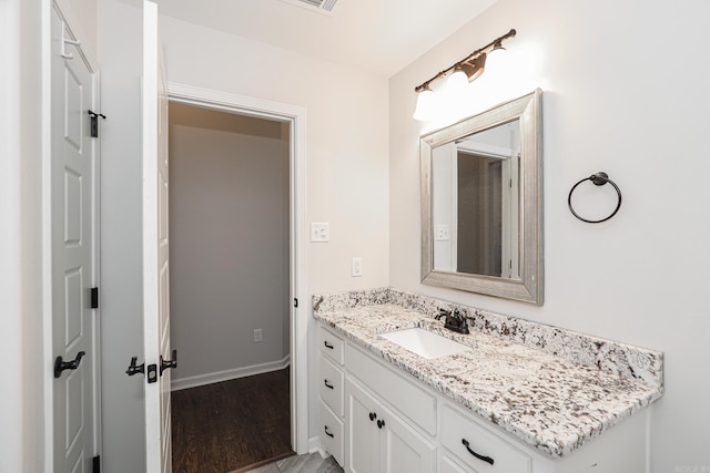 bathroom with hardwood / wood-style flooring and vanity